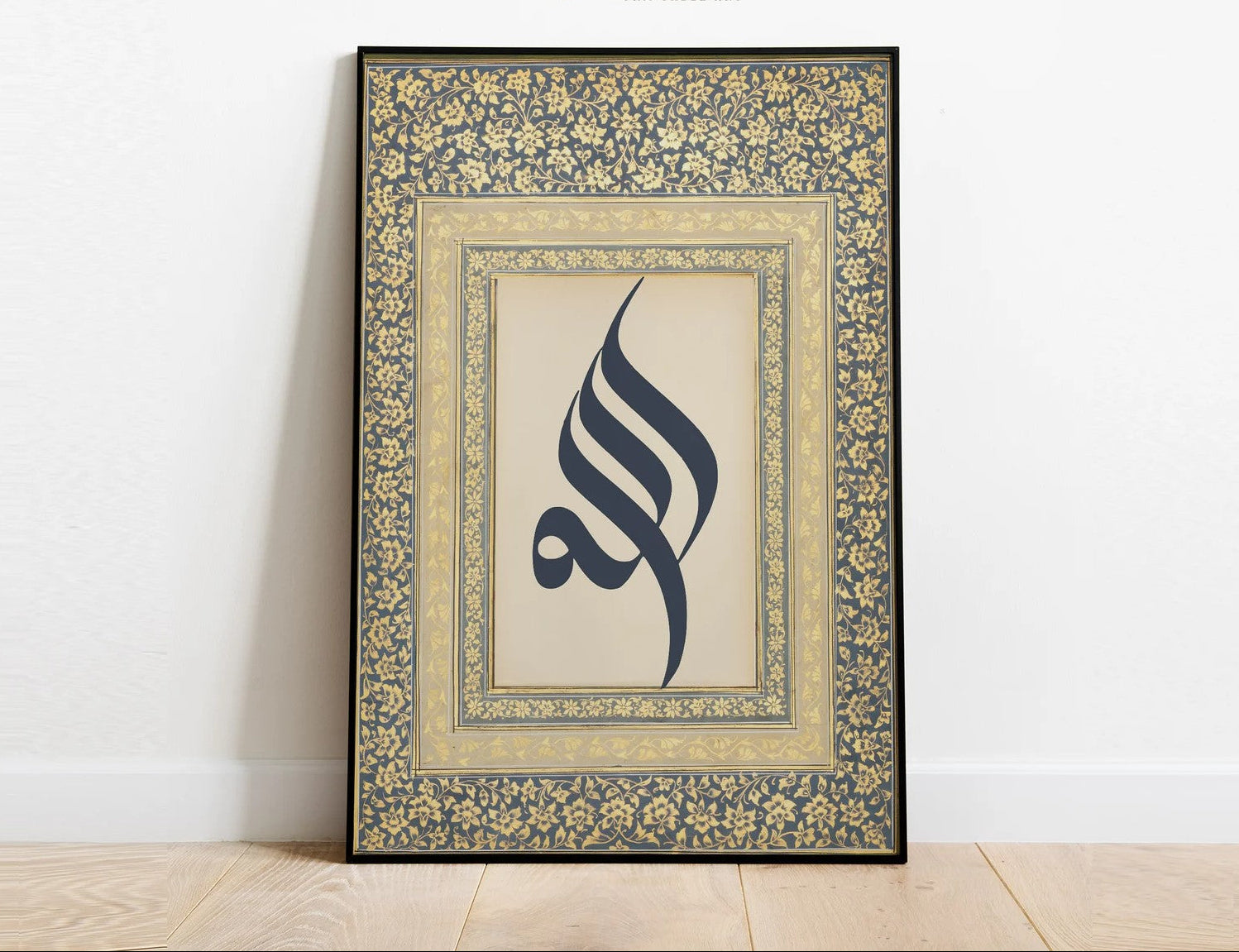 Decorative framed artwork with calligraphic design on a white wall.